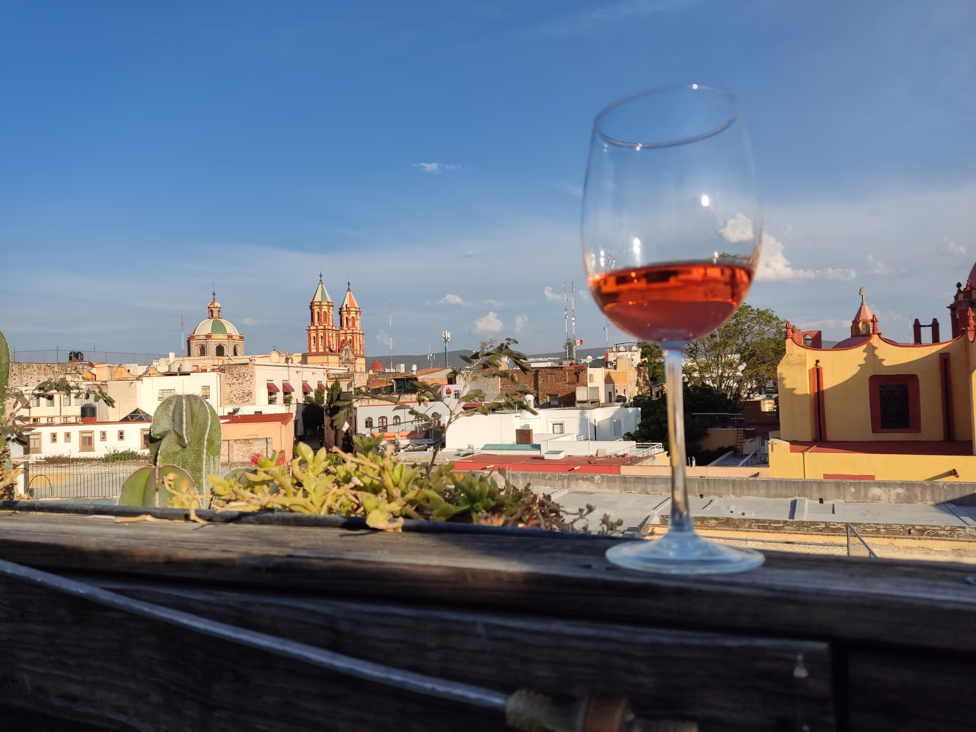 Rooftop view and wine glass from Terraza La Grupa in Queretaro, Mexico